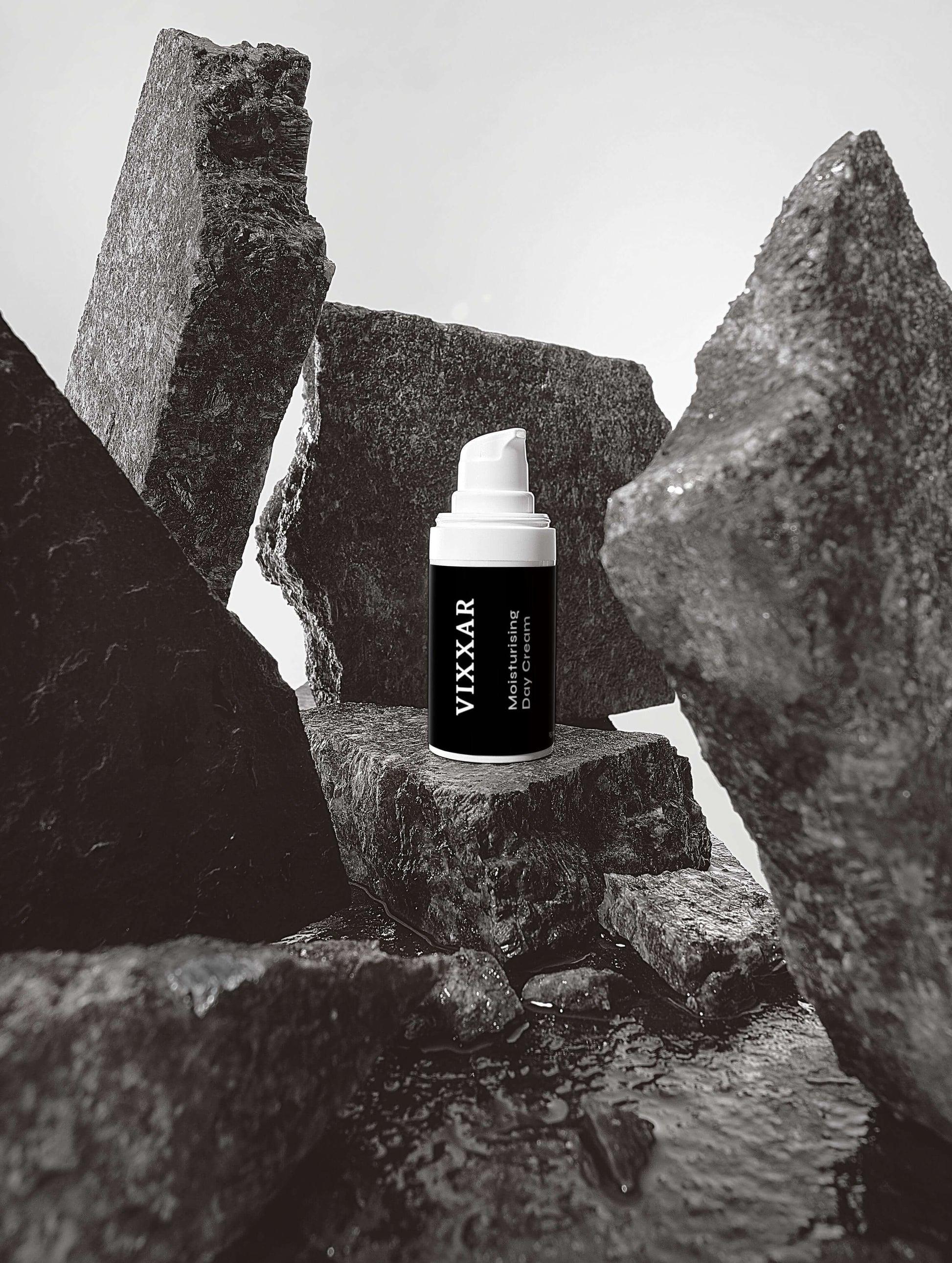 Vixxar Hydrating Skincare Serum surrounded by rocks, emphasizing nature-inspired anti-aging skincare.