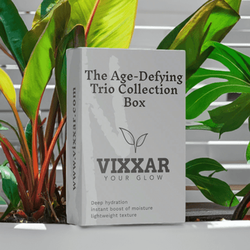 Vixxar Age-Defying Trio Collection Box amidst plants, offering anti-aging skincare with deep hydration and lightweight texture.