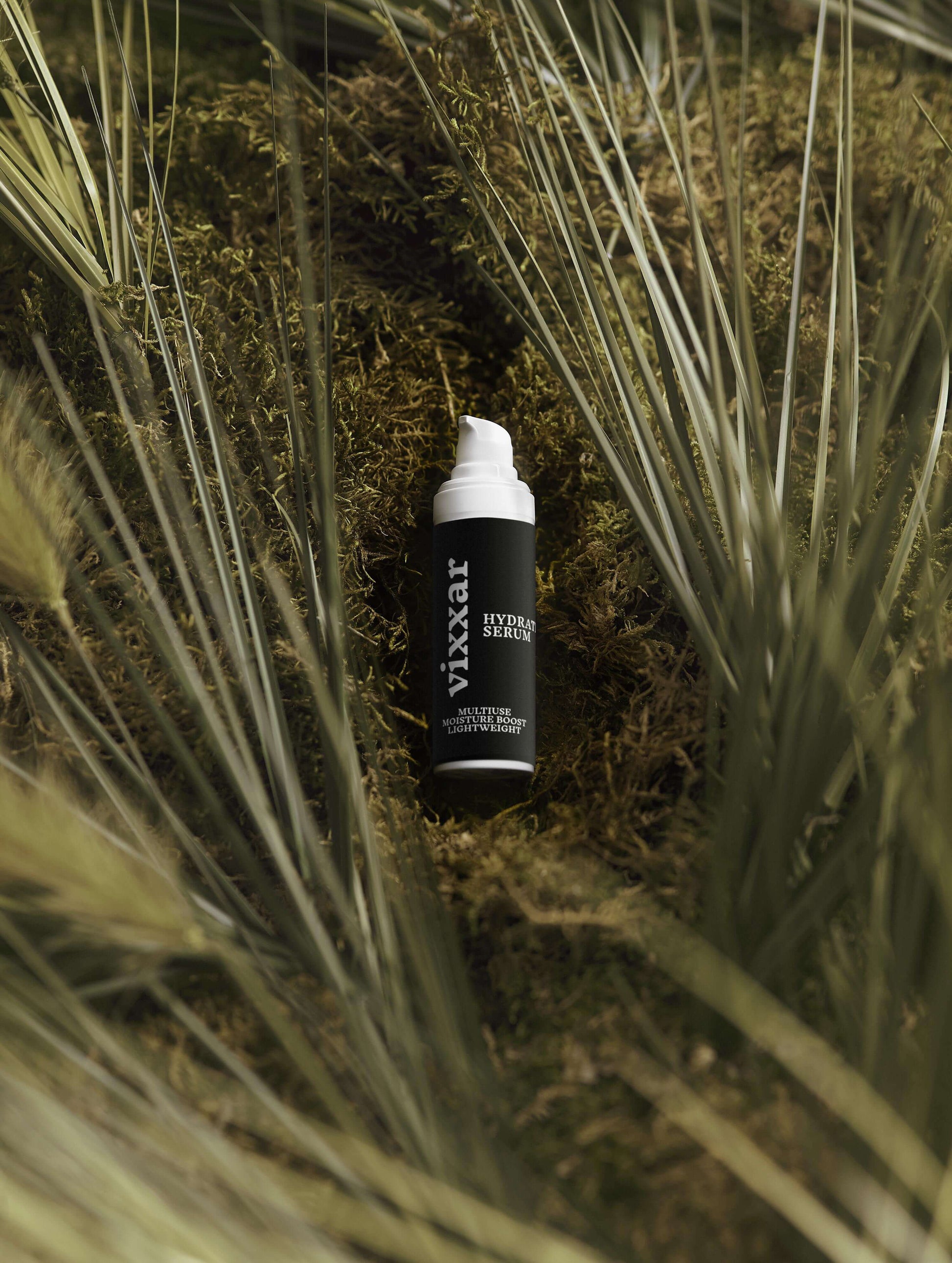 Hydrating Face Serum 30ml bottle nestled in greenery, featuring hyaluronic acid and botanicals for deep moisture and radiant skin.