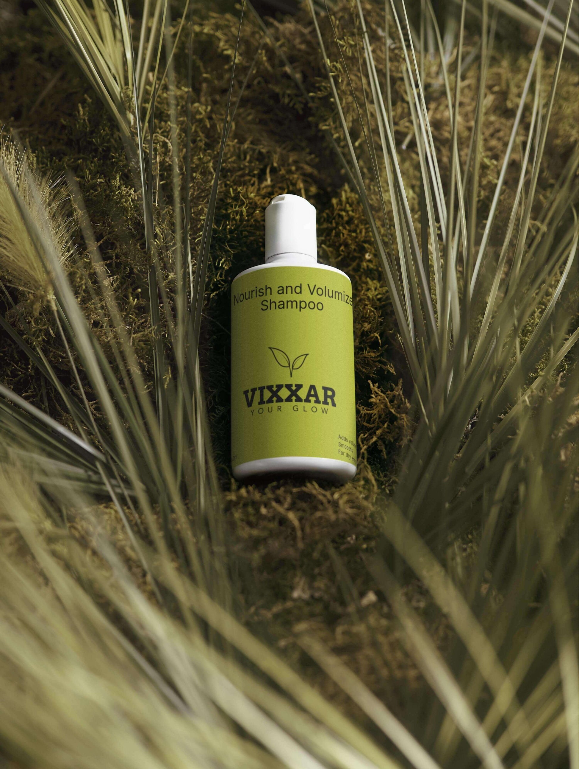 Nourish & Volumize Shampoo bottle on a grassy background, promoting strength and hydration for fuller hair.