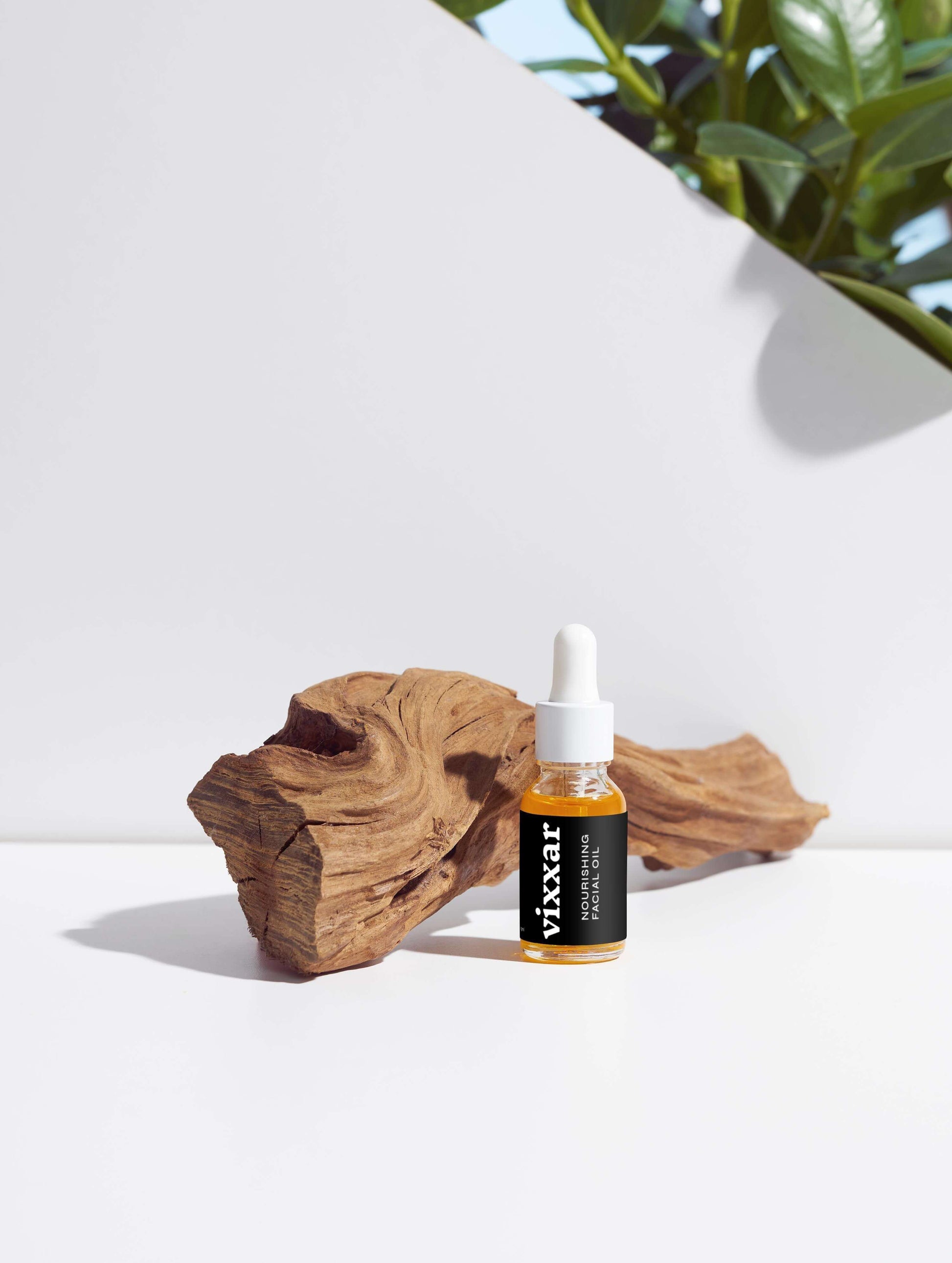 Organic Nourishing Facial Oil 15ml bottle displayed with natural wood, ideal for anti-aging and radiant skin care.