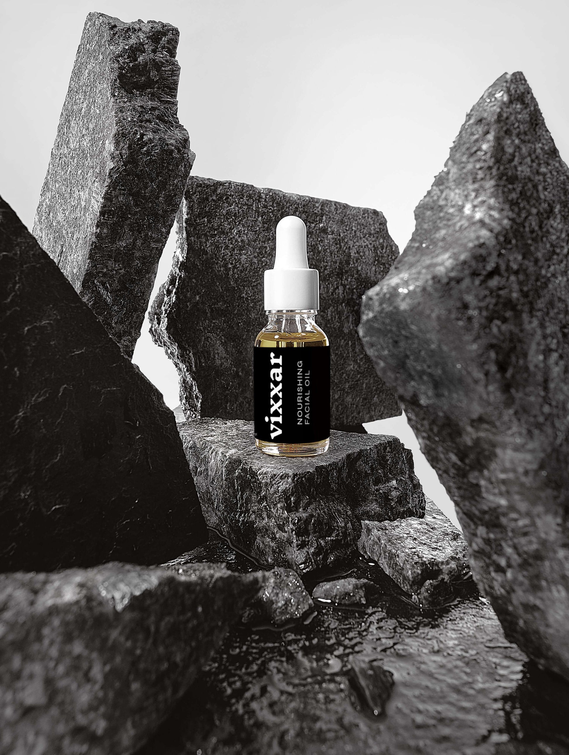 Vixar Nourishing Facial Oil 15ml among black stones, organic anti-aging oil for radiant skin, deep hydration and renewal.
