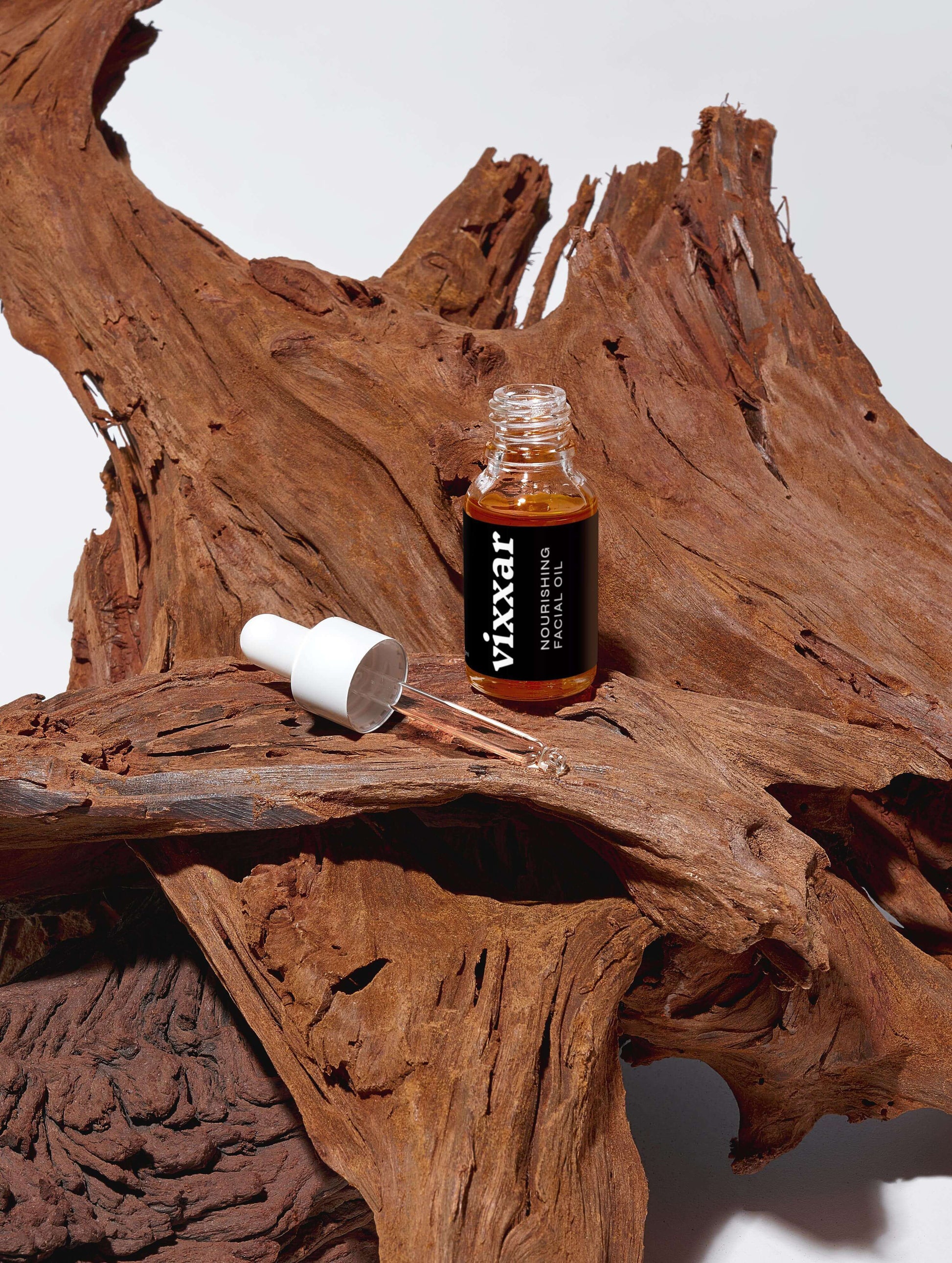 Nourishing Facial Oil 15ml - Organic anti-aging oil for radiant, youthful skin displayed on rustic wood background