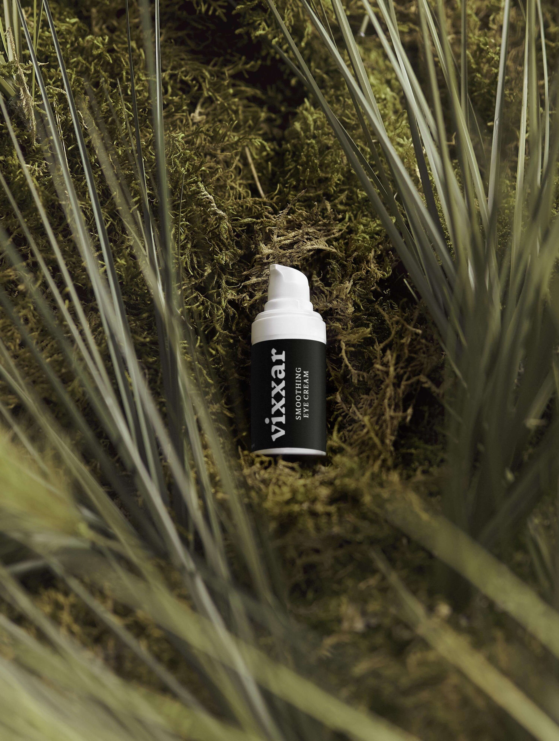 Smooth Hydrating Eye Cream 15ml bottle on a bed of green moss, highlighting the hydrate eye cream's natural ingredients and benefits.