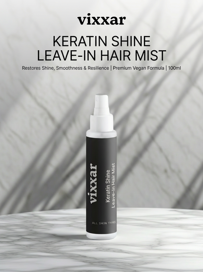 Vixxar Keratin Shine Leave-In Hair Mist bottle on a marble surface with a gray background