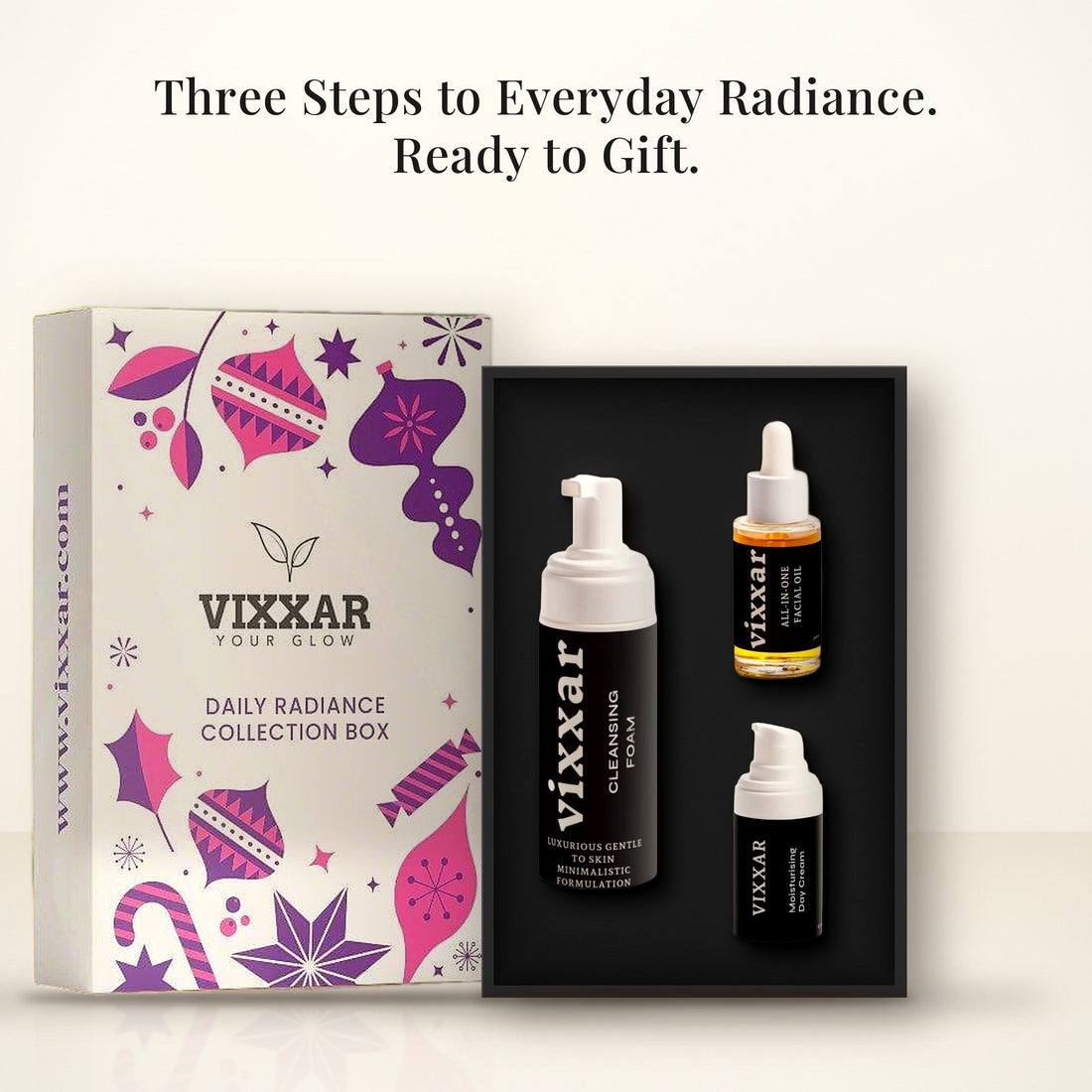 Open Vixxar Daily Radiance Collection Box: black inner box holding Cleansing Foam, All-In-One Facial Oil and Moisturising Day Cream beside the sleeve